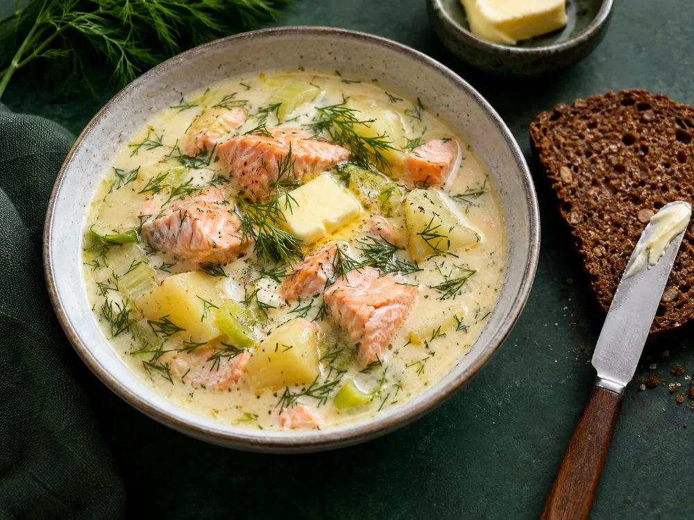 A bowl of Finnish creamy salmon soup with potato, leek and dill